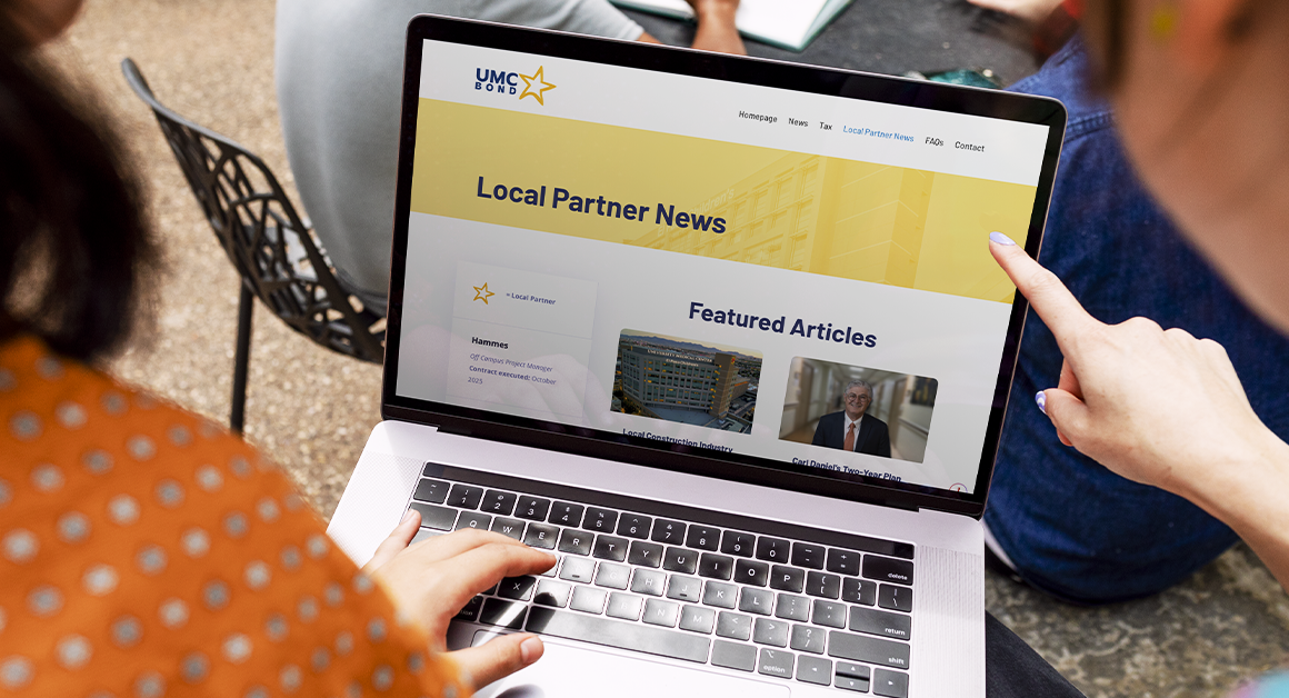 People viewing UMC’s Local Partner News webpage on a laptop, representing updates and collaboration with community partners