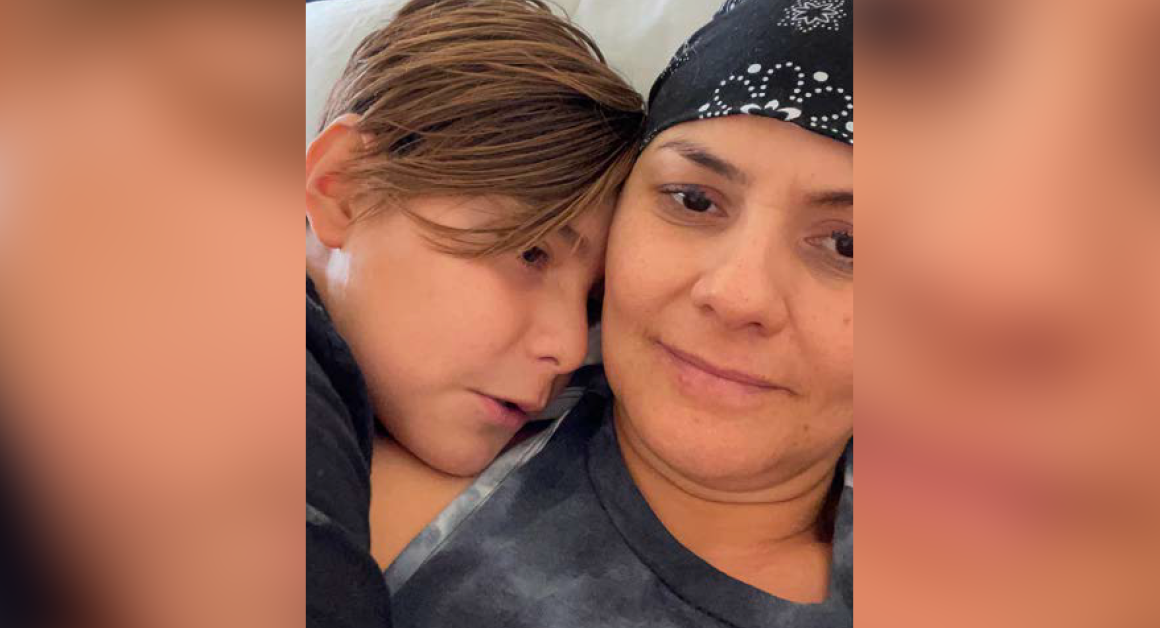 Close up picture of Claudia Yuridia Norris, cancer survivor, hugging her son.