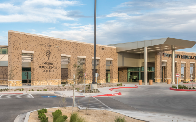 Exterior view of a University Medical Center of El Paso facility building with main entrance and parking area