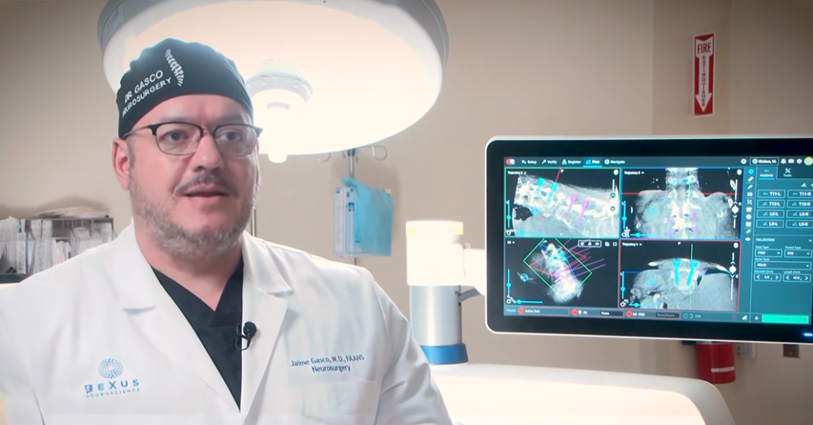 Neurosurgeon reviewing spinal imaging on a monitor, representing advanced spine procedures at UMC