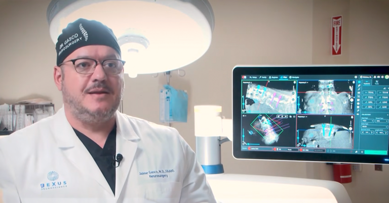 Neurosurgeon reviewing spinal imaging on a monitor, representing advanced spine procedures at UMC