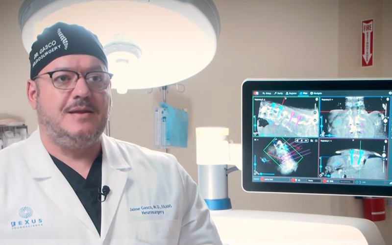 Neurosurgeon reviewing spinal imaging on a monitor, representing advanced spine procedures at UMC