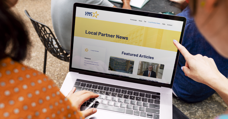 People viewing UMC’s Local Partner News webpage on a laptop, representing updates and collaboration with community partners