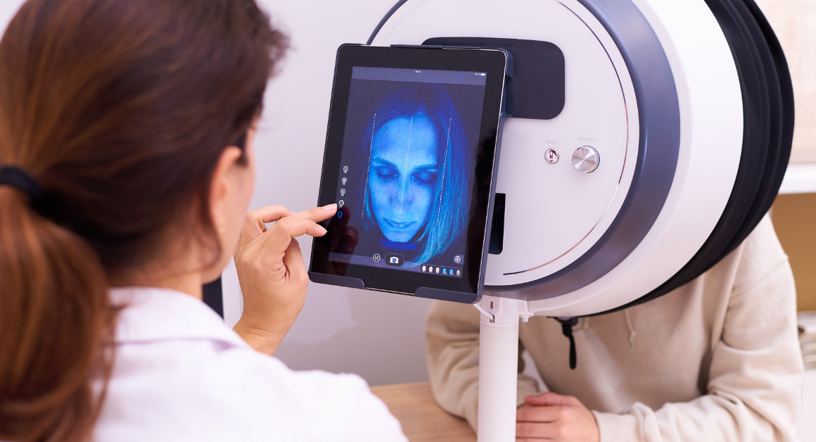 A dermatologist checking the skin of a person through a Skin Analysis Machine.