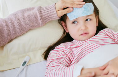 A child with a fever is being taken care of.