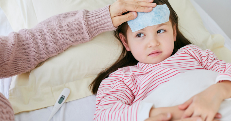 A child with a fever is being taken care of.