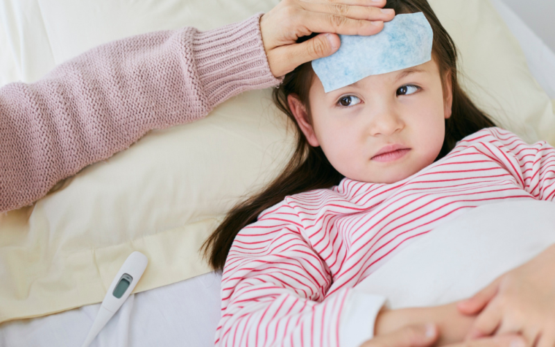 A child with a fever is being taken care of.