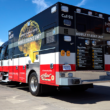UMC's Mobile Stroke Unit parked outside a fire station under a clear blue sky, conveying readiness and urgency.