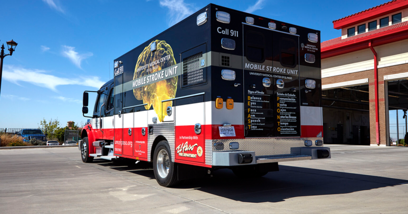 UMC's Mobile Stroke Unit parked outside a fire station under a clear blue sky, conveying readiness and urgency.