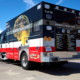 UMC's Mobile Stroke Unit parked outside a fire station under a clear blue sky, conveying readiness and urgency.