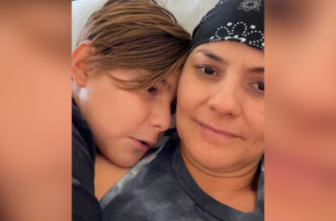 Close up picture of Claudia Yuridia Norris, cancer survivor, hugging her son.
