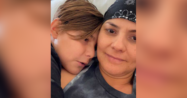 Close up picture of Claudia Yuridia Norris, cancer survivor, hugging her son.