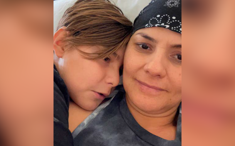 Close up picture of Claudia Yuridia Norris, cancer survivor, hugging her son.