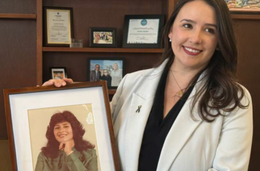 El Paso County Commissioner Jackie Butler holds a framed photo of her mother while sharing her family’s story to raise awareness about colorectal cancer screening.