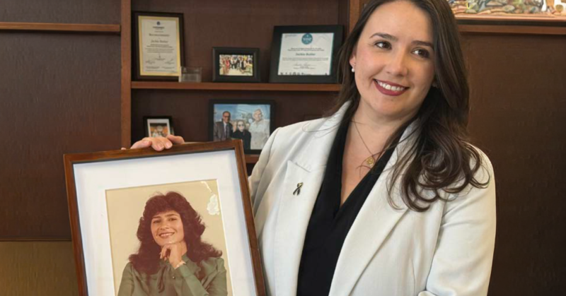 El Paso County Commissioner Jackie Butler holds a framed photo of her mother while sharing her family’s story to raise awareness about colorectal cancer screening.
