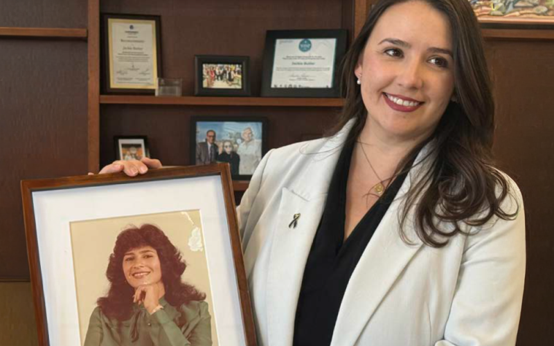 El Paso County Commissioner Jackie Butler holds a framed photo of her mother while sharing her family’s story to raise awareness about colorectal cancer screening.