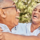 Older couple laughing together outdoors, reflecting connection, well-being, and healthy aging.