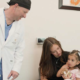 UMC healthcare provider meeting with a mother and young child during a pediatric cleft care appointment.