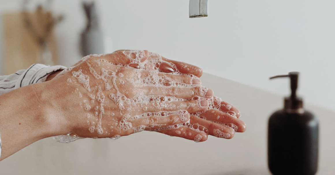 A person washes their hands with soap to help prevent the spread of germs and infections.