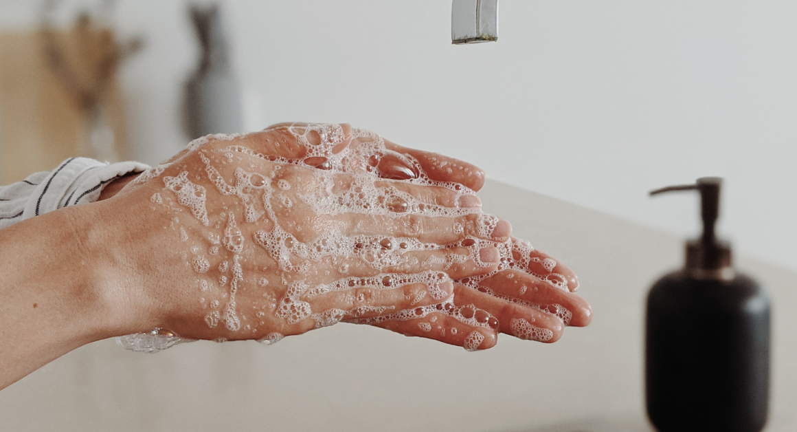A person washes their hands with soap to help prevent the spread of germs and infections.
