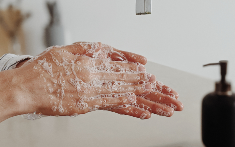 A person washes their hands with soap to help prevent the spread of germs and infections.